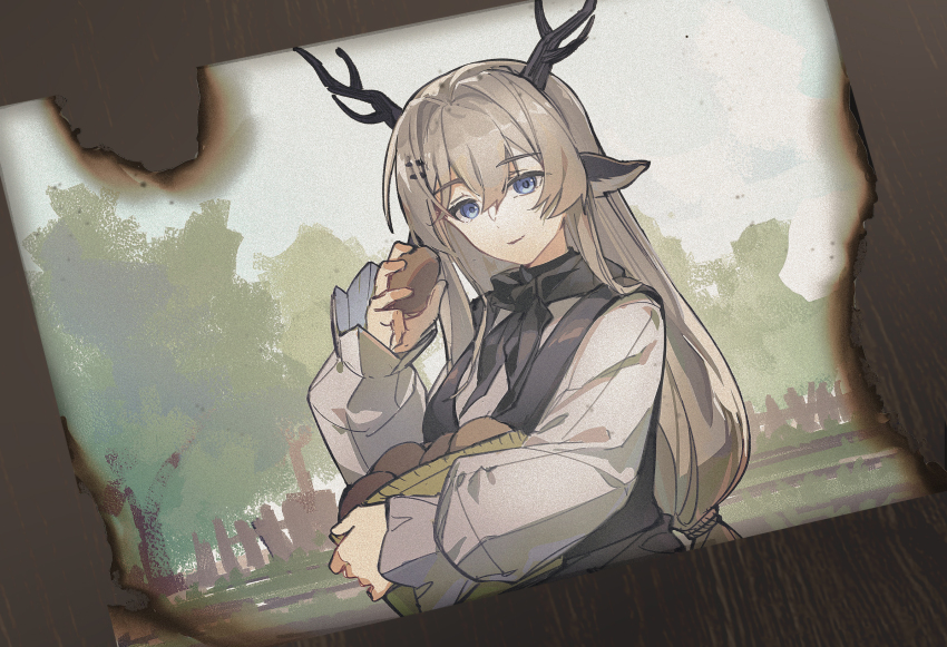 1girl alina_(arknights) animal_ears antlers arknights black_vest blue_eyes breasts brown_hair burnt commentary_request hair_between_eyes hair_ornament hairclip hand_up highres holding horns long_hair long_sleeves looking_at_viewer medium_breasts photo_(object) puffy_long_sleeves puffy_sleeves rockyroo shirt sleeves_past_wrists solo tree very_long_hair vest white_shirt