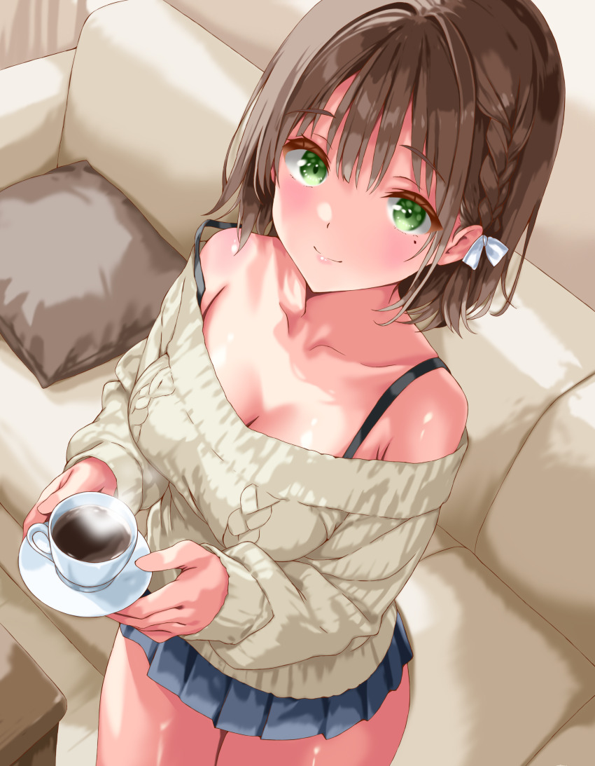 1girl absurdres bare_shoulders black_skirt braid breasts brown_hair brown_sweater cleavage closed_mouth collarbone couch cowboy_shot cup green_eyes highres holding holding_cup iwato_(celler) looking_at_viewer medium_breasts medium_hair miniskirt missing_commentary mole mole_under_eye off-shoulder_sweater off_shoulder original pleated_skirt skirt smile solo strap_slip sweater teacup