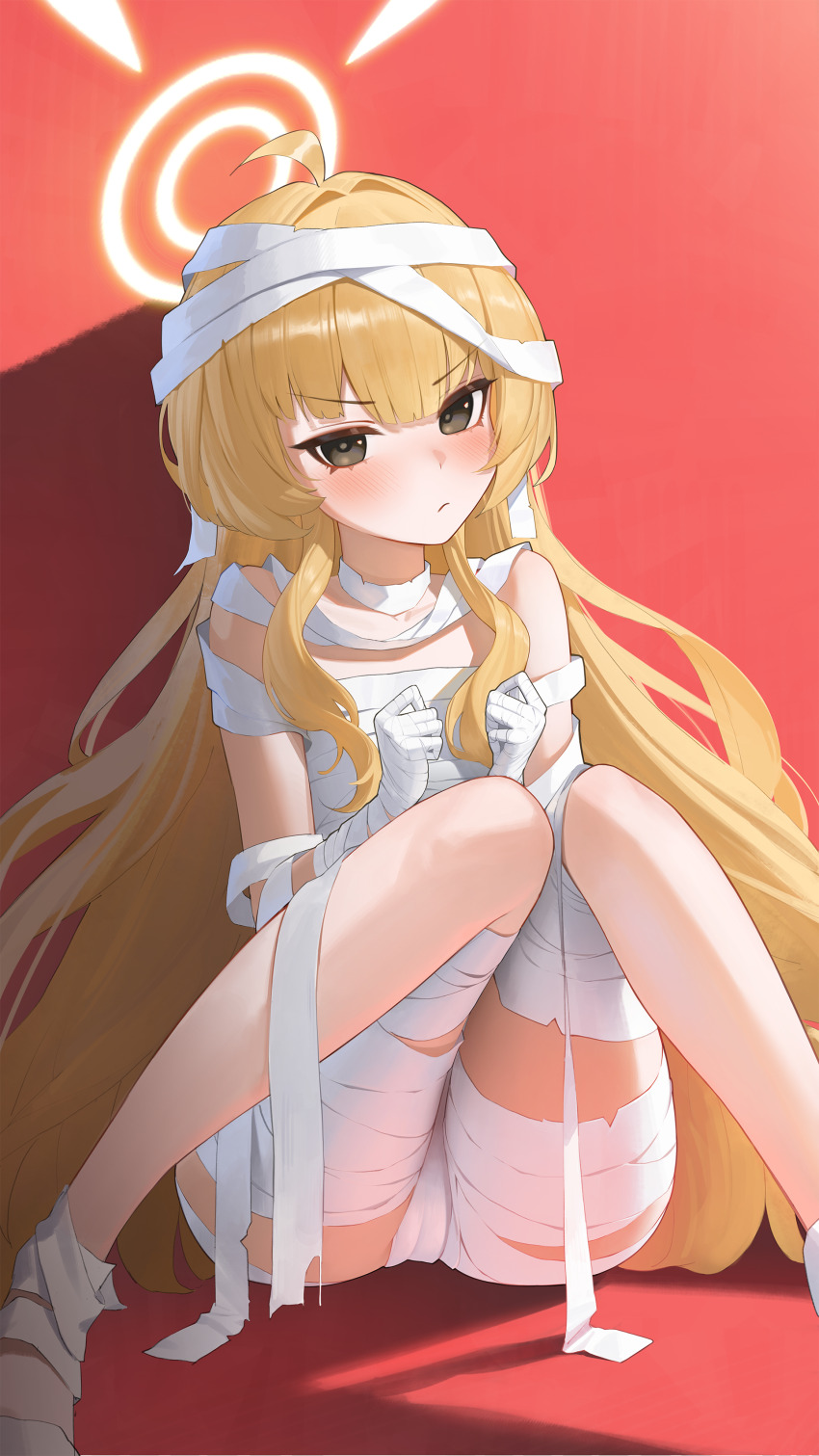 1girl absurdres bandaged_hand bandages black_eyes blonde_hair blue_archive blush cameltoe closed_mouth commentary hair_between_eyes halloween_costume halo hantata highres long_hair looking_at_viewer mummy_costume red_background shadow simple_background sitting solo very_long_hair yoshimi_(blue_archive) yoshimi_(halloween)_(blue_archive)
