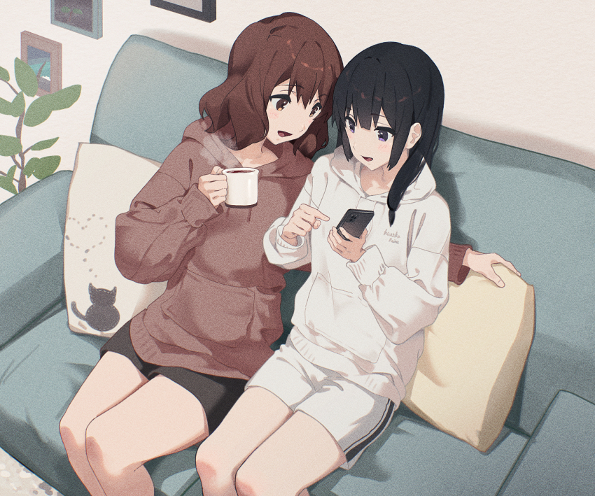 2girls black_hair black_shorts blush brown_eyes brown_hair brown_hoodie cellphone coffee_mug commentary_request couch cup cushion film_grain hibike!_euphonium highres holding holding_cup holding_phone hood hoodie indoors kousaka_reina lie_lack1080 long_hair long_sleeves medium_hair mug multiple_girls on_couch open_mouth oumae_kumiko phone purple_eyes shorts smartphone smile white_hoodie white_shorts yuri