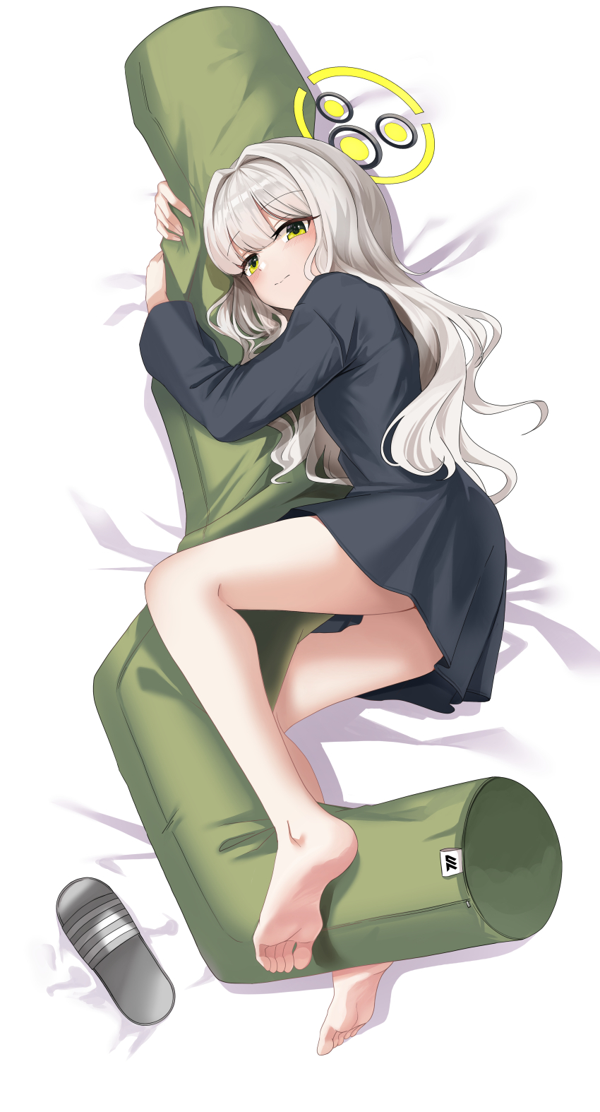 1girl absurdres bare_legs barefoot bed_sheet black_pajamas blue_archive blunt_bangs blush closed_mouth commentary dakimakura_(medium) feet full_body green_eyes hair_down hair_intakes halo hands_up hare_(blue_archive) hare_(pajamas)_(blue_archive) highres hugging_object leehong_studio long_hair long_sleeves looking_at_viewer lying millennium_science_school_logo official_alternate_costume on_side pajamas soles solo split_mouth thighs toes wavy_hair yellow_halo