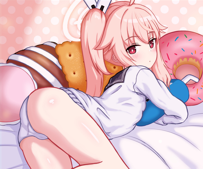 1girl ass blue_archive blush cardigan closed_mouth commentary dot_mouth feet_out_of_frame halo highres io9 long_sleeves looking_at_viewer looking_back lying natsu_(blue_archive) no_pants hugging_object on_stomach panties pink_eyes pink_hair pink_halo shiny_skin side_ponytail solo thighs underwear white_cardigan white_panties