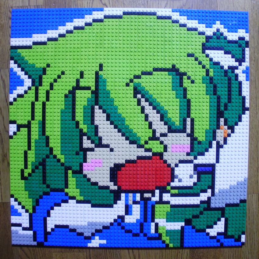 1girl ^_^ arm_up blush_stickers closed_eyes derivative_work closed_eyes female_focus frog_hair_ornament green_hair hair_ornament highres kochiya_sanae lego lego_(medium) open_mouth photo_(medium) pixel_art smile solo table touhou unconventional_media upper_body you_rei_(blowback)