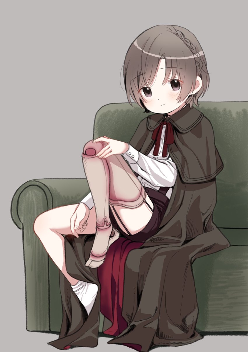 1boy amputee black_cape black_shorts blush braid cape capelet child couch grey_background high-waist_shorts highres looking_at_viewer male_focus original piko_(pixiv) prosthesis prosthetic_leg shorts simple_background sitting socks solo trap