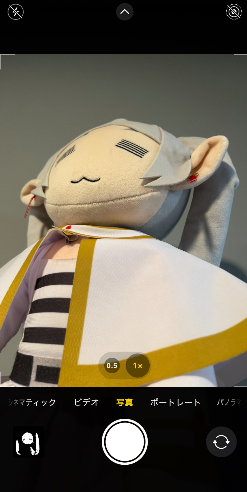 :3 camera_view capelet closed_eyes earrings frieren grey_hair highres ios_(os) jewelry meme official_art photo_(medium) sousou_no_frieren stuffed_toy twintails upward_angle_frieren_drawing_(meme) white_capelet