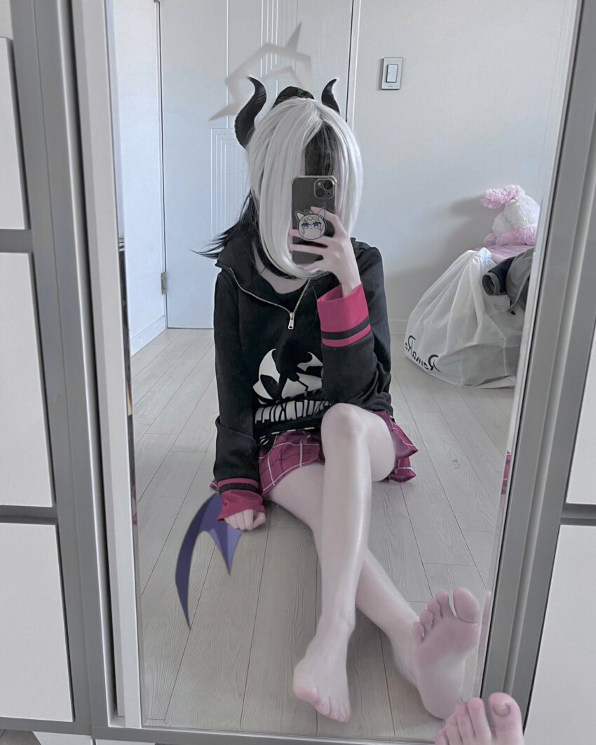 1girl bag bare_legs barefoot black_hair blue_archive cellphone cosplay covered_face dal_(aazsxx2) door feet halo highres holding holding_phone hood hood_down hoodie horns kayoko_(blue_archive) light_switch mirror nails no_shoes pale_skin panels phone photo_(medium) real_life sitting skirt smartphone soles stuffed_toy toenails toes white_hair wooden_floor zipper