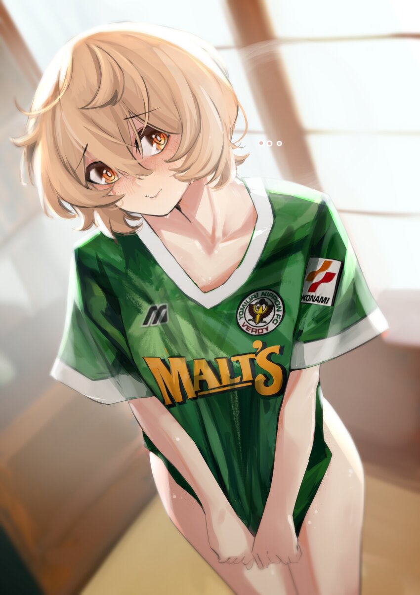 ... 1girl absurdres blonde_hair blurry blurry_background brown_eyes clio_aite closed_mouth collarbone freckles green_shirt hair_between_eyes highres naked_shirt no_pants phase_connect pupi_(rain_prophet) shirt short_hair smile soccer_uniform solo sportswear sweat tokyo_verdy virtual_youtuber