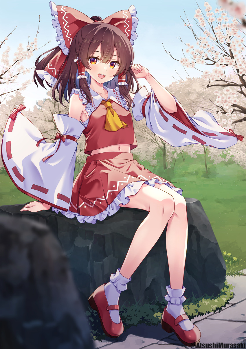 1girl bare_shoulders blush bow brown_hair day detached_sleeves frilled_skirt frills full_body hair_bow hair_tubes hakurei_reimu highres japanese_clothes long_hair murasaki_atsushi navel nontraditional_miko open_mouth outdoors red_bow red_shoes red_skirt ribbon-trimmed_sleeves ribbon_trim shoes sidelocks sitting skirt smile socks solo touhou twitter_username white_sleeves white_socks wide_sleeves yellow_eyes