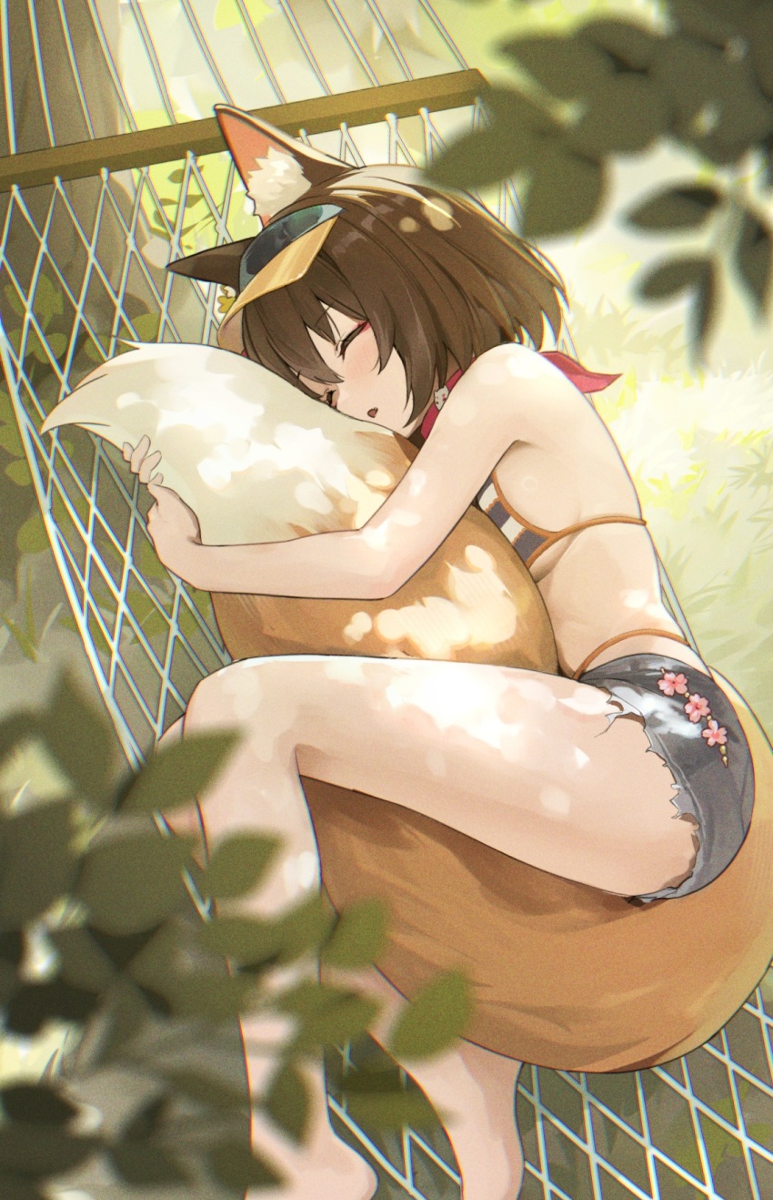 1girl animal_ear_fluff animal_ears between_legs bikini_under_shorts blue_archive blurry blurry_foreground blush breasts brown_hair closed_eyes commentary fox_ears fox_girl fox_tail grey_shorts hammock highres holding_own_tail hugging_own_tail hugging_tail izuna_(blue_archive) izuna_(swimsuit)_(blue_archive) lying medium_breasts official_alternate_costume on_hammock on_side outdoors parted_lips short_hair shorts sideboob sleeping solo tail tail_between_legs tem_(tempainting1) visor_cap