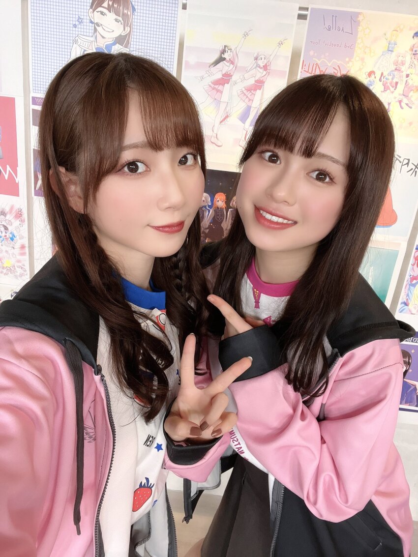 2girls aoyama_nagisa costume emori_aya highres indoors looking_at_viewer multiple_girls photo_(medium) simple_background smile standing