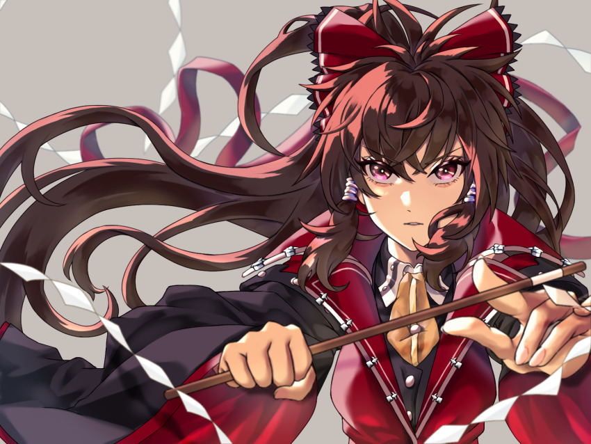 1girl adapted_costume bow brown_hair commentary_request gohei grey_background hair_bow hair_tubes hakurei_reimu highres koumajou_densetsu long_hair looking_at_viewer mizu_ichig0 parted_lips purple_eyes solo touhou wide_sleeves wind wind_lift