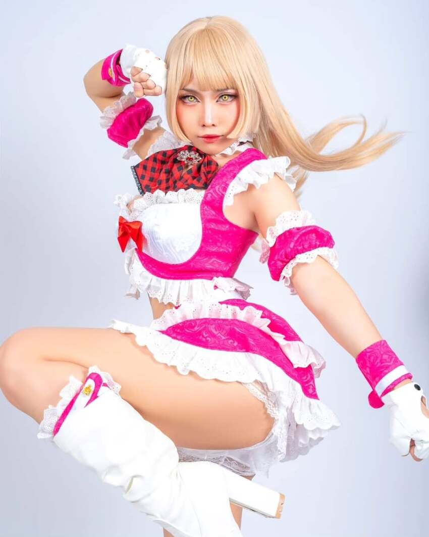 1girl ass bare_shoulders blonde_hair boots breasts cosplay cosplay_photo crop_top emilie_de_rochefort emilie_de_rochefort_(cosplay) fingerless_gloves gloves grey_background high_heels highres long_hair looking_at_viewer panties photo_(medium) real_life skirt sleeveless standing standing_on_one_leg tekken tekken_tag_tournament_2 thighs underwear y.yorenji yellow_eyes