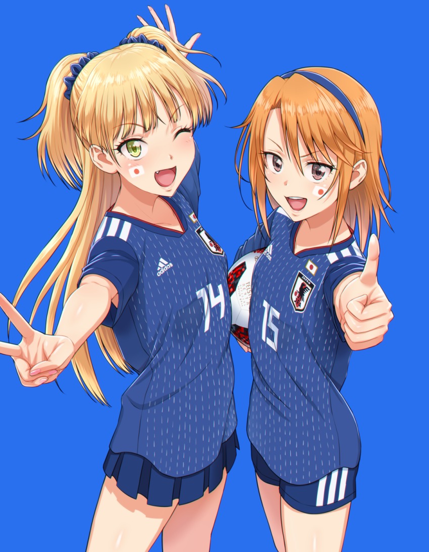 2018_fifa_world_cup 2girls ;d adidas ball blonde_hair blue_background blush brown_eyes clothes_writing facepaint fang green_eyes hairband highres holding idolmaster idolmaster_cinderella_girls japan japanese_flag jougasaki_rika long_hair looking_at_viewer multiple_girls nigou one_eye_closed open_mouth orange_hair outstretched_arms scrunchie short_sleeves shorts simple_background skirt smile soccer_ball soccer_uniform sportswear standing thumbs_up two_side_up v world_cup yuuki_haru