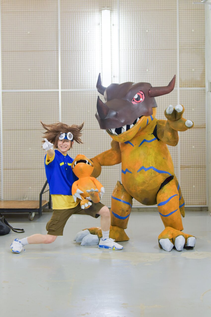 absurdres agumon cosplay digimon goggles goggles_on_head greymon greymon_(cosplay) highres horns photo_(medium) real_life smile yagami_taichi yagami_taichi_(cosplay)