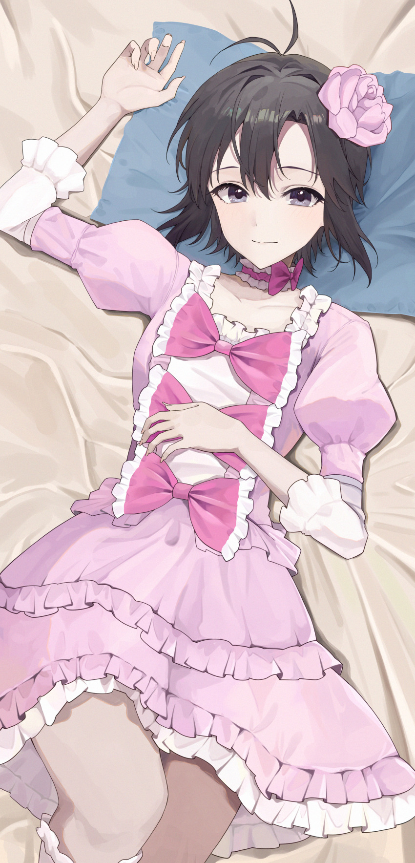 1girl absurdres antenna_hair bed_sheet black_hair closed_mouth dress flower frilled_dress frills grey_eyes hair_flower hair_ornament highres idolmaster idolmaster_(classic) juliet_sleeves kikuchi_makoto light_smile long_sleeves looking_at_viewer lying on_back on_bed pink_dress pink_flower puffy_sleeves short_hair solo yaki_tai