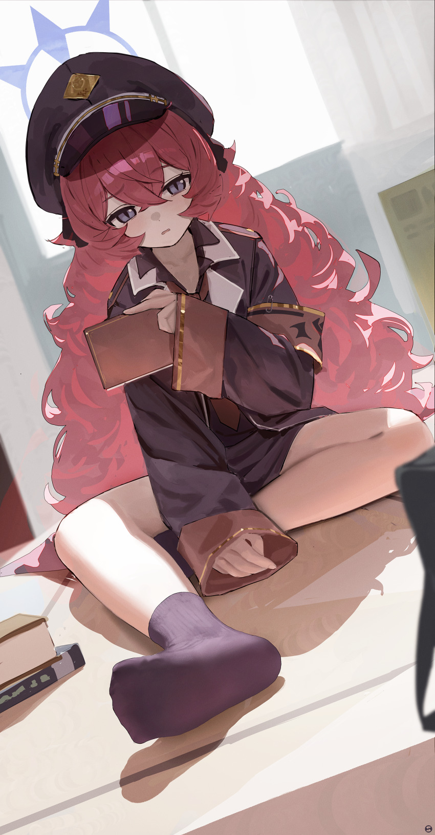 1girl absurdres armband black_hat black_jacket black_shirt black_skirt black_socks blue_archive book commentary_request crossed_bangs fluffy_hair hair_between_eyes halo hat highres holding holding_book indoors iroha_(blue_archive) jacket loli long_hair looking_at_viewer open_mouth peaked_cap purple_eyes purple_halo red_armband red_hair shirt sitting skirt slit_pupils socks soles solo songchuan_li