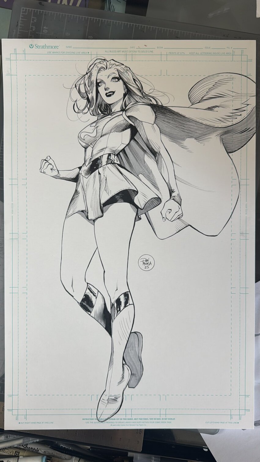1girl belt black_lips black_shorts boots cape clenched_hands dan_mora dc_comics floating_cape greyscale grin highres legs long_hair long_sleeves looking_at_viewer marker_(medium) miniskirt monochrome photo_(medium) shorts signature skirt smile solo supergirl superhero_costume superman_(series) thighs toned toned_female traditional_media