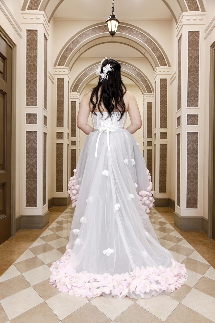 1girl asian ass black_hair breasts bride chouzuki_maryou cleavage dress highres lipstick makeup photo_(medium) plump solo wedding_dress