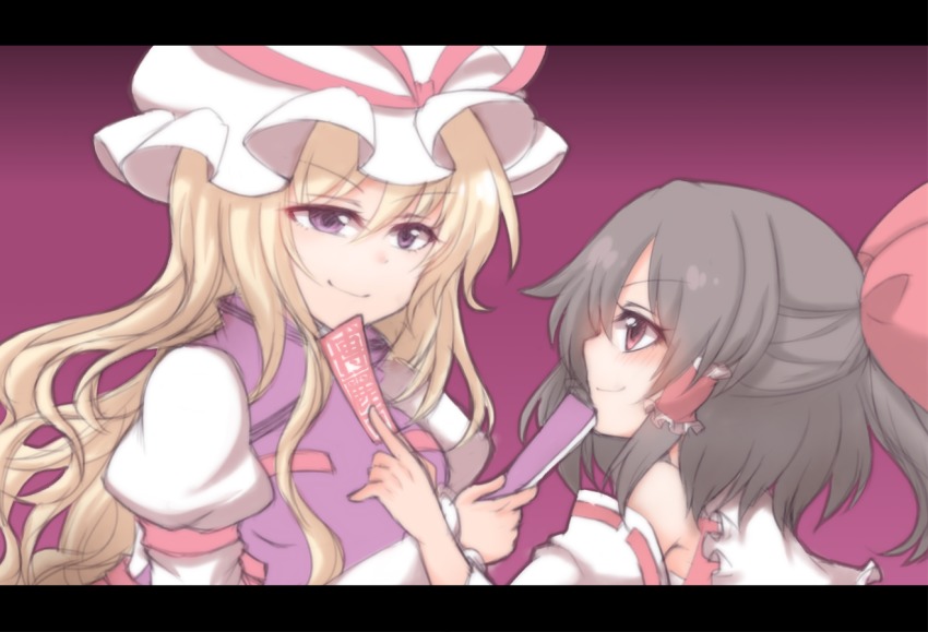2girls bare_shoulders black_hair blonde_hair bow commentary_request detached_sleeves folding_fan hair_bow hair_tubes hakurei_reimu hand_fan hat hat_ribbon holding holding_fan holding_paper juliet_sleeves letterboxed long_hair long_sleeves looking_at_another mob_cap multiple_girls ofuda paper puffy_sleeves purple_eyes red_bow red_eyes red_ribbon ribbon shiohachi smile touhou upper_body white_hat yakumo_yukari