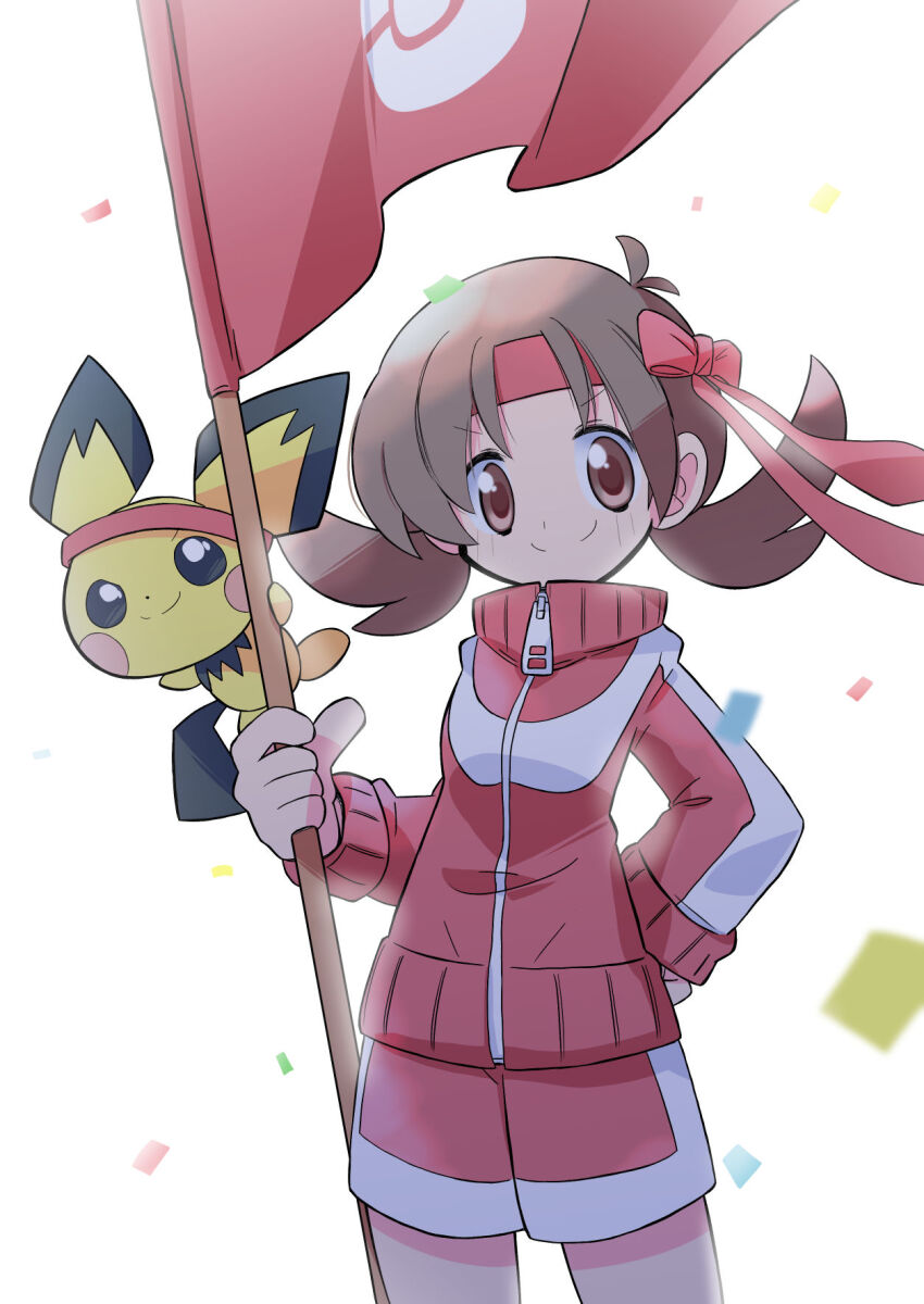 1girl brown_eyes brown_hair closed_mouth confetti flag gen_2_pokemon headband highres holding holding_flag jacket long_sleeves looking_at_viewer low_twintails lyra_(pokemon) nintendo pichu pokemon pokemon_hgss rascal_(feuille) red_flag red_headband red_jacket red_shorts shorts smile track_jacket twintails white_background