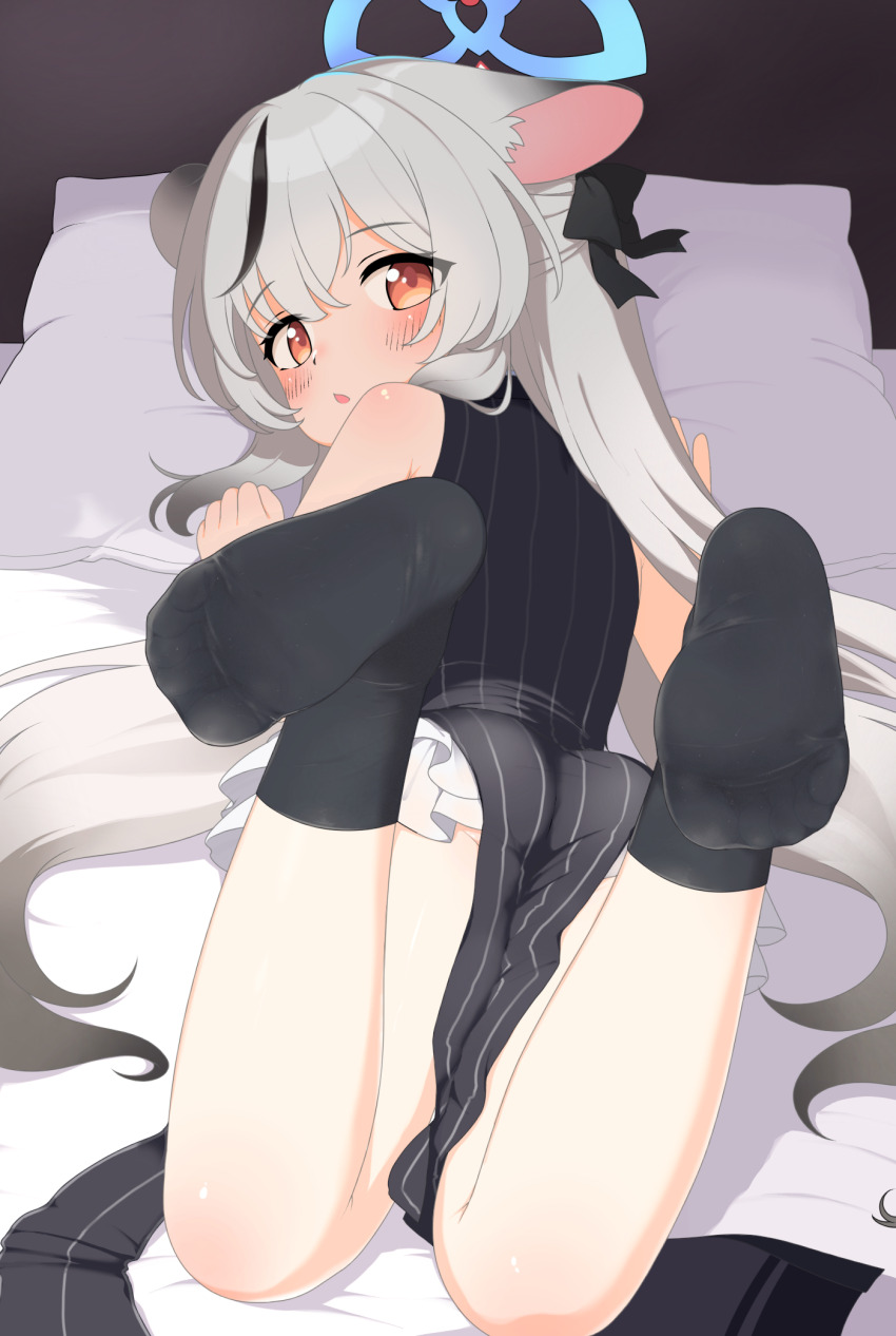 1girl black_hair black_socks blue_archive blue_halo commentary_request didac_fantasy dress from_behind grey_hair halo highres kokona_(blue_archive) long_hair looking_at_viewer looking_back lying multicolored_hair no_shoes on_stomach orange_eyes pelvic_curtain sleeveless sleeveless_dress socks soles solo streaked_hair tagme