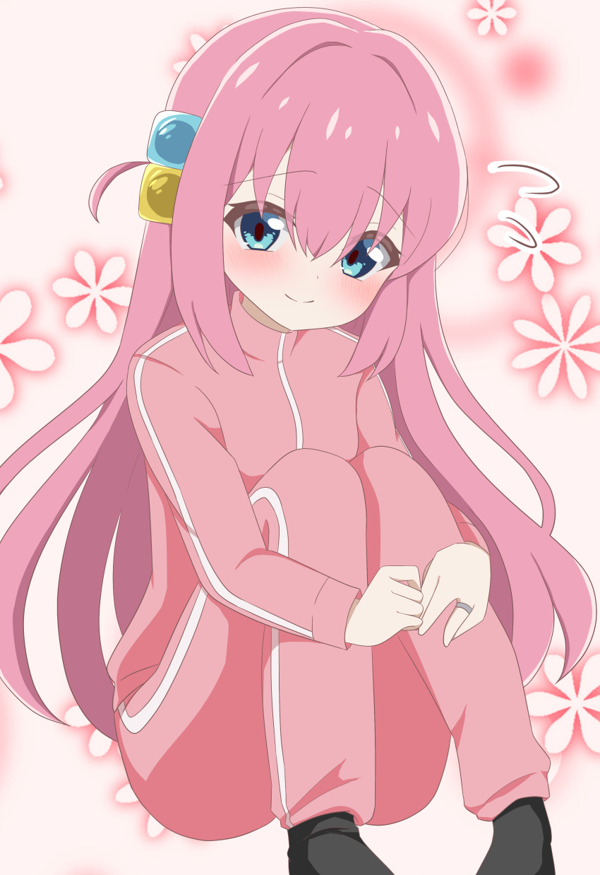 1girl absurdres black_socks blue_eyes blush bocchi_the_rock! child closed_mouth commentary_request cube_hair_ornament dot_nose floral_background full_body gotoh_hitori hair_between_eyes hair_intakes hair_ornament highres hrtahm hugging_own_legs invisible_floor jacket jewelry long_bangs long_hair long_sleeves looking_at_viewer no_shoes pants pink_hair pink_jacket pink_pants pink_theme raised_inner_eyebrows ring sitting smile socks solo split_mouth straight_hair track_jacket track_pants very_long_hair wispy_bangs