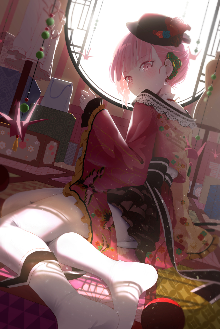 1girl absurdres akiyama_mizuki black_hat closed_mouth commentary_request earrings floral_print flower hair_flower hair_ornament hand_up hat hat_flower highres indoors japanese_clothes jewelry kawaranu_atatakasa_no_tonari_de_(project_sekai) kimono long_sleeves looking_at_viewer looking_back no_shoes nun_nu origami pantyhose paper_crane pink_eyes pink_hair print_kimono project_sekai reclining red_kimono short_hair solo white_pantyhose wide_sleeves yarn yarn_ball