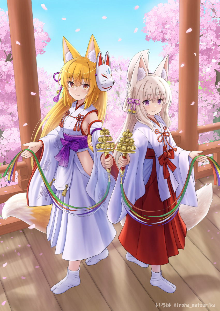 2girls absurdres animal_ear_fluff animal_ears bell blonde_hair blue_sky blush breasts brown_eyes brown_hair cherry_blossoms closed_mouth commentary_request day detached_sleeves flower folded_ponytail fox_ears fox_girl fox_mask fox_tail hair_between_eyes hakama hakama_skirt highres hip_vent holding iroha_(iroha_matsurika) japanese_clothes jingle_bell kagura_suzu kimono kohaku_(iroha_(iroha_matsurika)) koyoi_(iroha_(iroha_matsurika)) long_hair long_sleeves looking_at_viewer mask mask_on_head medium_breasts miko multiple_girls no_shoes original outdoors pink_flower purple_eyes red_hakama sideboob skirt sky sleeveless sleeveless_kimono smile socks tabi tail tree very_long_hair white_hakama white_kimono white_sleeves white_socks wide_sleeves