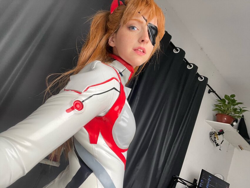1girl blue_eyes bodysuit brazilian_(nationality) breasts brown_hair cosplay evangelion:_3.0+1.0_thrice_upon_a_time freckles highres indoors interface_headset_(evangelion) lips looking_at_viewer looking_back mecha_pilot_suit memepantazis neon_genesis_evangelion photo_(medium) plugsuit_(evangelion) rebuild_of_evangelion shiny_clothes solo souryuu_asuka_langley souryuu_asuka_langley_(cosplay) standing twintails two_side_up white_bodysuit
