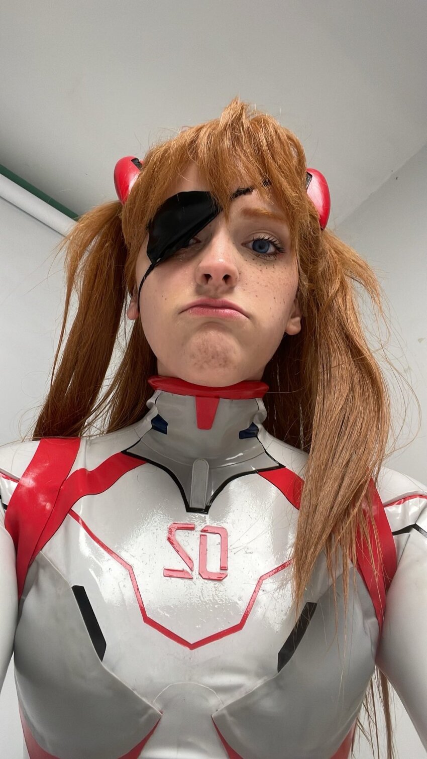 1girl blue_eyes bodysuit brazilian_(nationality) breasts brown_hair cosplay evangelion:_3.0+1.0_thrice_upon_a_time eyepatch eyepatch_lift freckles highres interface_headset_(evangelion) lips looking_at_viewer mecha_pilot_suit memepantazis neon_genesis_evangelion photo_(medium) plugsuit_(evangelion) portrait rebuild_of_evangelion shiny_clothes small_breasts solo souryuu_asuka_langley souryuu_asuka_langley_(cosplay) standing twintails two_side_up white_bodysuit