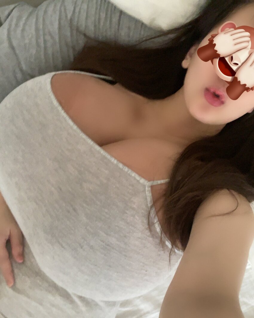 1girl asian breasts brown_hair cleavage highres huge_breasts japanese_(nationality) large_breasts long_hair on_bed photo_(medium) real_life selfie shirt spaghetti_strap tagme tanaka_hitomi visible_ears white_shirt
