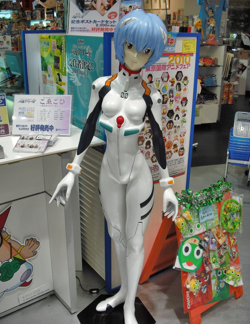 1girl anpanman anpanman_(character) atom_(tetsuwan_atom) ayanami_rei ben_10 ben_10:_alien_force ben_tennyson beyblade bleach blue_hair blue_shirt bodysuit breasts cartoon_network character_print doraemon doraemon_(character) dororo_(keroro_gunsou) edogawa_conan fairy_tail figure giroro hagane_gingka hair_ornament hershel_layton highres interface_headset_(evangelion) keroro keroro_gunsou kurosaki_ichigo kururu_(keroro_gunsou) looking_at_viewer mecha_pilot_suit meitantei_conan metal_fight_beyblade namco naruto_(series) natsu_dragneel neon_genesis_evangelion pac-man pac-man_(game) photo_(medium) plugsuit_(evangelion) poster_(object) print_shirt professor_layton red_eyes shirt short_hair small_breasts standing tamagotchi tamama tetsuwan_atom unico_(character) uzumaki_naruto white_bodysuit