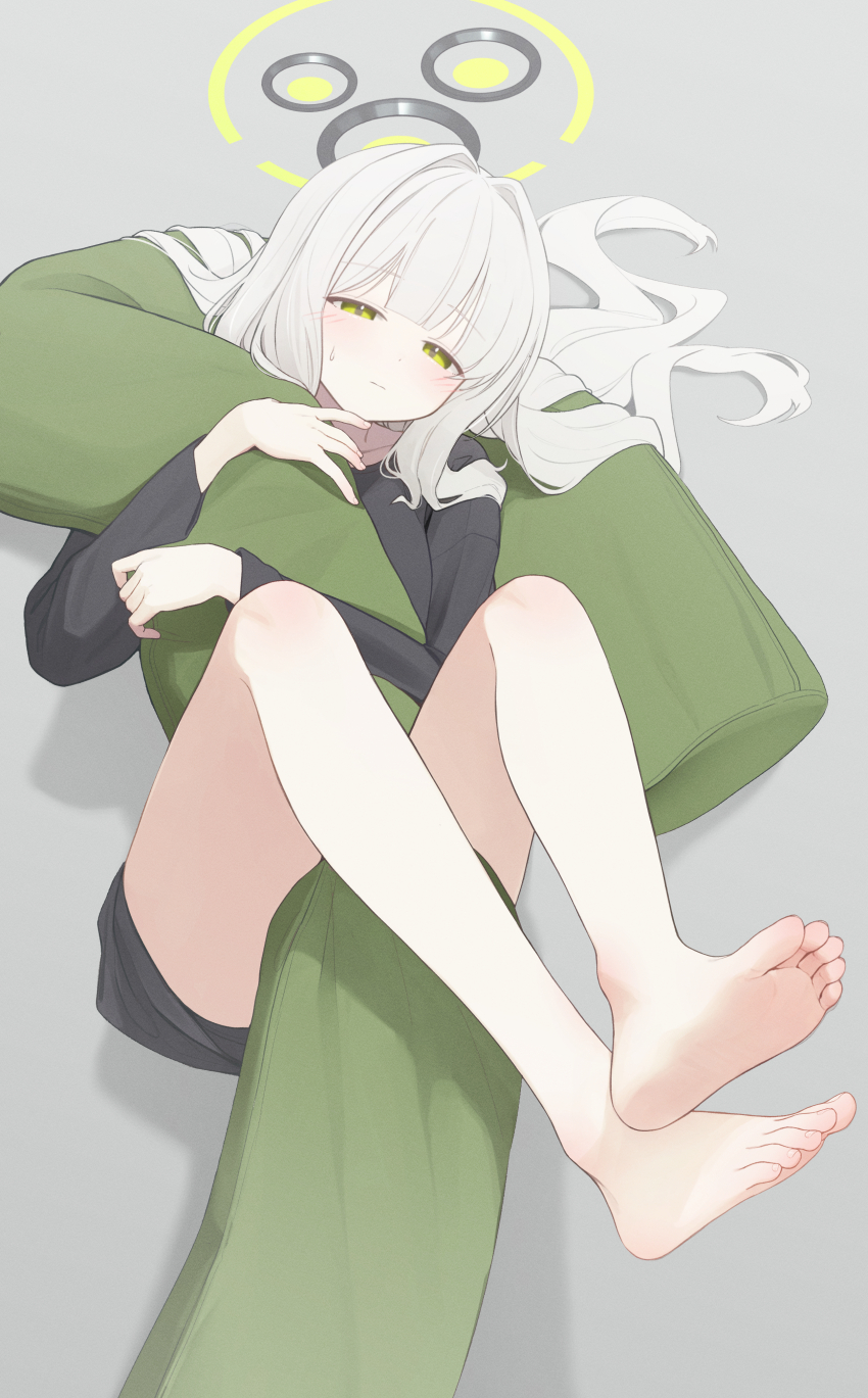 1girl absurdres barefoot blue_archive blunt_bangs blush closed_mouth commentary_request feet green_eyes green_halo grey_background grey_hair halo hare_(blue_archive) hare_(pajamas)_(blue_archive) highres holding hugging_object kabanoki legs long_hair long_sleeves looking_at_viewer lying official_alternate_costume on_back pajamas pillow shirt sidelocks simple_background soles solo thighs toes