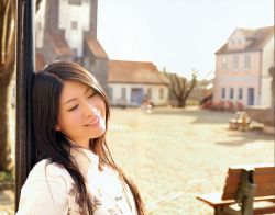  bench black_hair building chihara_minori closed_eyes highres house leaning long_hair outdoors photo_(medium) smile teeth tree voice_actor window 