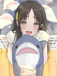  1girl blurry blurry_background blush brown_eyes brown_hair commentary_request from_above gakuen_idolmaster hair_ornament highres holding holding_stuffed_toy idolmaster ikea_shark kuramoto_china long_hair looking_at_viewer open_mouth parted_bangs pleading_eyes shirt slime_kouhai smile solo sparkle sparkling_eyes straight_hair stuffed_animal stuffed_shark stuffed_toy teeth upper_teeth_only white_shirt wooden_floor 