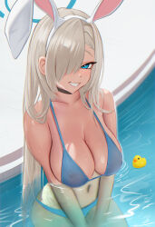  1girl animal_ears asuna_(blue_archive) bikini blonde_hair blue_archive blue_bikini blue_eyes blue_halo breasts covered_erect_nipples fake_animal_ears grin hair_over_one_eye halo highres huge_breasts long_hair looking_at_viewer navel partially_submerged pool rabbit_ears rubber_duck smile solo swimsuit teeth ultratesla v_arms water wet 