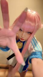 1girl blue_eyes capcom cosplay_photo dougi female_focus fingernails hime_cut looking_at_viewer manon_legrand manon_legrand_(cosplay) off_shoulder photo_(medium) pink_hair real_life short_hair_with_long_locks sidelocks solo street_fighter street_fighter_6 vega_mao