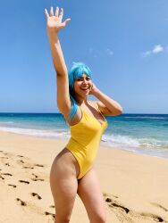  1girl beach blue_hair cosplay cosplay_photo day dragon_ball dragonball_z female_focus highres jennysan looking_at_viewer maron_(dragon_ball) ocean one-piece_swimsuit photo_(medium) puerto_rican_(nationality) sand smile solo swimsuit thick_thighs thighs yellow_one-piece_swimsuit 