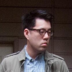  1boy albert_yi asian black_hair blue_shirt closed_mouth collared_jacket collared_shirt danbooru_(site) film_grain frown glasses grey_jacket jacket lowres male_focus open_clothes open_jacket photo_(medium) plaid_clothes plaid_shirt real_life shirt short_hair solo upper_body 