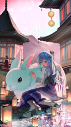  1girl animal black_footwear blue_eyes blue_hair building chinese_zodiac commentary_request grey_footwear hair_between_eyes hakama hakama_skirt highres japanese_clothes kimono lantern long_hair long_sleeves original outdoors oversized_animal purple_hakama rabbit saraki shoe_soles skirt solo white_kimono wide_sleeves year_of_the_rabbit  rating:General score:2 user:danbooru