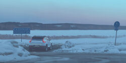 absurdres car cloud cloudy_sky day highres motor_vehicle no_humans outdoors road road_sign scenery sign simon_stalenhag sky snow sports_utility_vehicle swedish_machines swedish_text