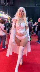 1girl 6+others animated argentine_(nationality) blonde_hair blue_eyes breasts cape corset cosplay curvy elbow_gloves emma_frost emma_frost_(cosplay) gloves highres marvel medium_breasts multiple_others panties photo_(medium) red_lips revealing_clothes short_hair smile solo sophie_valentine tagme thighhighs underwear video walking white_cape white_corset white_gloves white_panties white_thighhighs wide_hips x-men