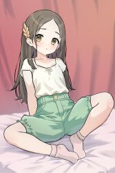 1girl bed_sheet blush bobby_socks brown_eyes brown_hair closed_mouth collarbone eyelashes full_body gakuen_idolmaster green_shorts hair_ornament highres idolmaster kuramoto_china long_hair looking_at_viewer mwm5 parted_bangs shirt shorts sitting socks solo white_shirt white_socks