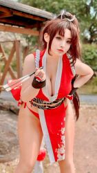 1girl breasts brown_hair cleavage closed_mouth cosplay cosplay_photo fatal_fury female_focus highres large_breasts long_hair looking_at_viewer photo_(medium) ponytail real_life ririnacos shiranui_mai shiranui_mai_(cosplay) snk solo