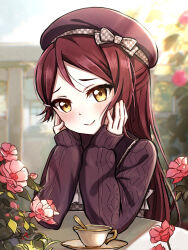1girl beret blurry blurry_background blush bow brown_eyes cable_knit cafe checkered_bow checkered_clothes closed_mouth cup day elbows_on_table flower hair_ornament hairclip hands_on_own_face hat hat_bow head_rest highres long_hair long_sleeves looking_at_viewer love_live! love_live!_sunshine!! outdoors pink_flower purple_hat purple_sweater red_hair sakurauchi_riko saucer shouchan sleeves_past_wrists smile solo sweater table teacup upper_body
