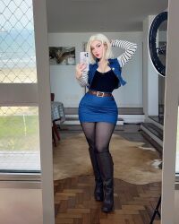 Rule 34 | 1girl, android 18, android 18 (cosplay), black pantyhose, blonde hair, brazilian (nationality), breasts, cleavage, cosplay, denim, denim skirt, dragon ball, dragonball z, facing viewer, fegalvao, full body, highres, legs, long legs, looking at viewer, medium breasts, medium hair, pantyhose, photo (medium), real life, selfie, sexually suggestive, short hair, skirt, solo, straight-on, thick thighs, thighs, wide hips