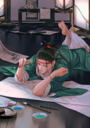 1boy akyo89 barefoot black_hair bowl chinese_clothes eyelashes feet_up green_robe hair_bun hair_ornament hair_pulled_back half_updo hands_up hanfu hanging_scroll headband holding holding_paintbrush indoors inkwell lantern long_hair long_sleeves lying male_focus on_floor on_stomach jiangnan_baijingtu paint paintbrush paintbrush_hair_ornament paper robe scroll shen_zhou single_hair_bun sleeves_rolled_up soles solo wooden_floor