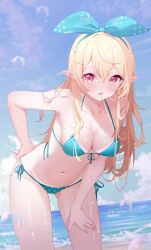 1girl ahoge beach bikini bikini_tan blonde_hair blue_sky breasts cleavage commentary deyui english_commentary front-tie_bikini_top front-tie_top green_ribbon hair_ornament hair_ribbon halterneck highres jewelry long_hair looking_at_viewer medium_breasts navel nijisanji nijisanji_en ocean open_mouth pointy_ears pomu_rainpuff red_eyes ribbon ring side-tie_bikini_bottom sky string_bikini swimsuit tan tanline virtual_youtuber wedding_ring