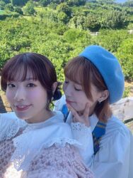 2girls blurry earrings furihata_ai japanese_(nationality) jewelry looking_at_viewer multiple_girls outdoors photo_(medium) real_life saito_shuka selfie short_hair tree voice_actor