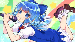 1girl blue_bow blue_dress blue_eyes blue_hair blush bobby_socks bow cirno commentary_request dress hair_bow holding holding_microphone ice ice_wings looking_at_viewer lying microphone mogamiya_honu neck_ribbon on_stomach red_ribbon ribbon shoes short_hair short_sleeves snowflakes socks solo star_(symbol) touhou white_socks wings